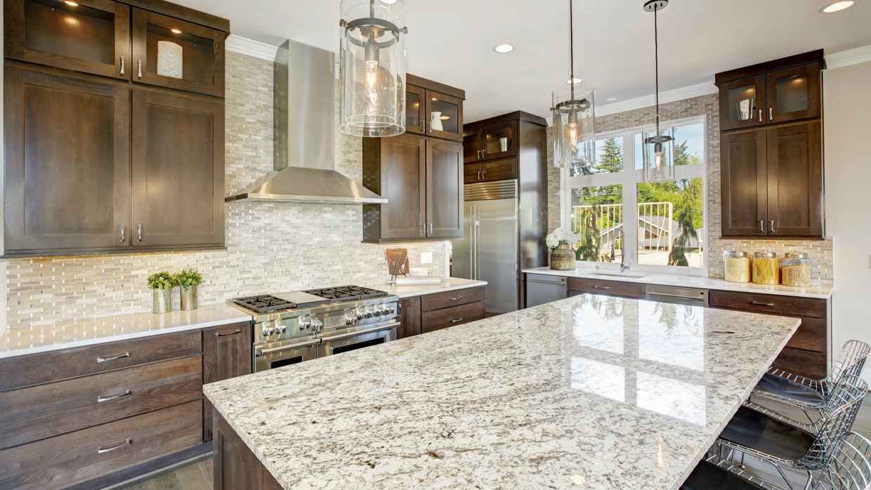 Luxury kitchen with premium granite countertops and wood cabinetry by Stone Link LLC